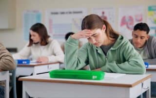 A student upset in class showing that she may not be enrolled at the right school.