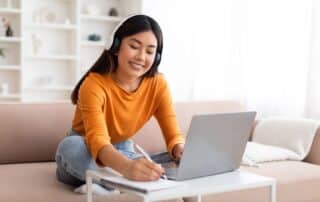 a student taking an online college prep course in the comfort of her own home.