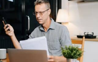 A parent reviewing school documentation on a laptop while preparing for TEFA and special education planning.
